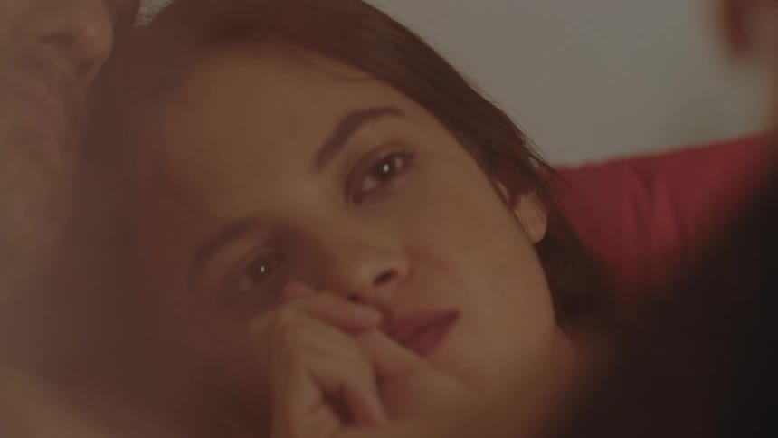 Two romantic partner lying on a bed all loved up