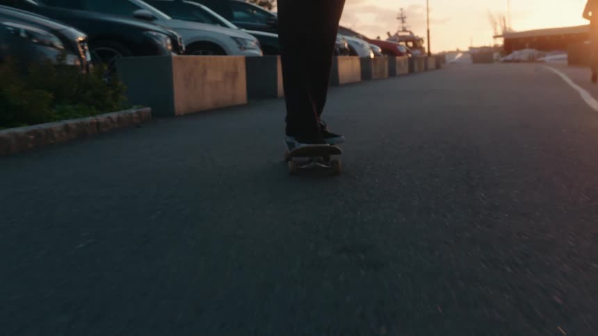 There are people skateboarding in the middle of the road