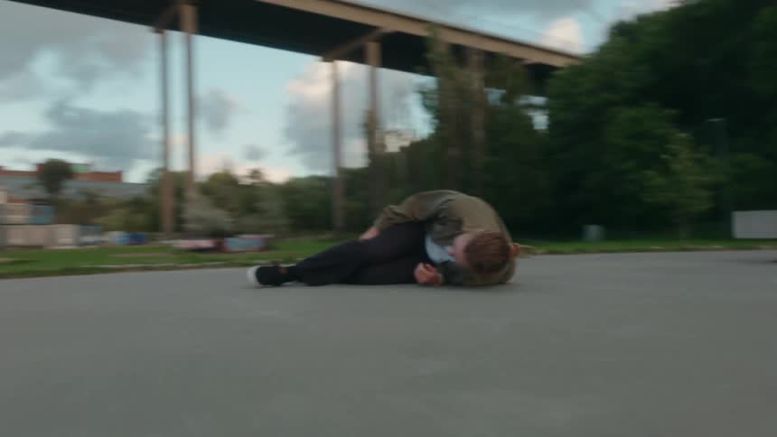 A man is skateboadring outdoors during spring