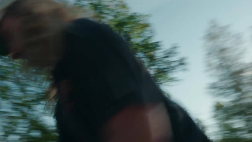 A man is skateboarding at a park during spring