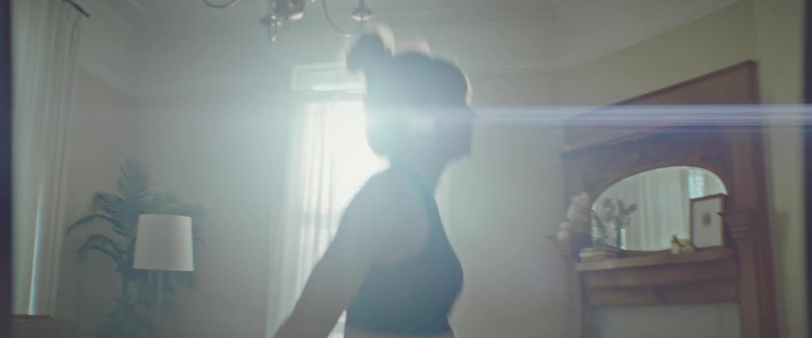 A woman is working out in the living room