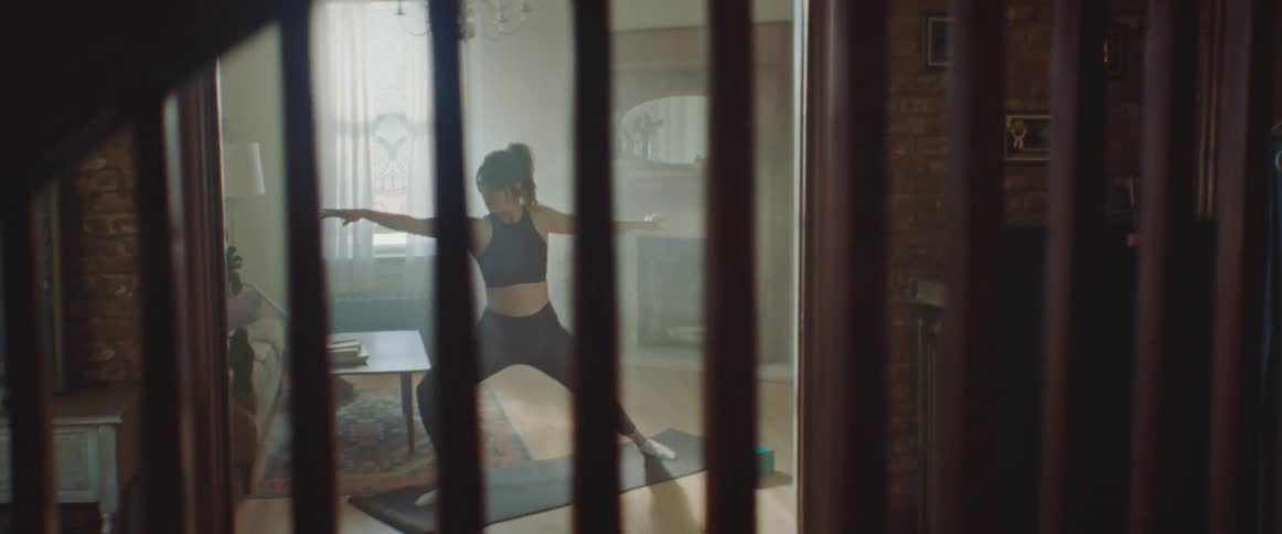 A young woman does yoga at home
