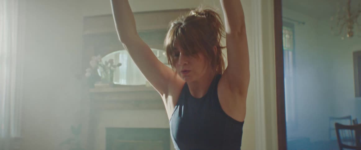 A woman is doing yoga in her living room