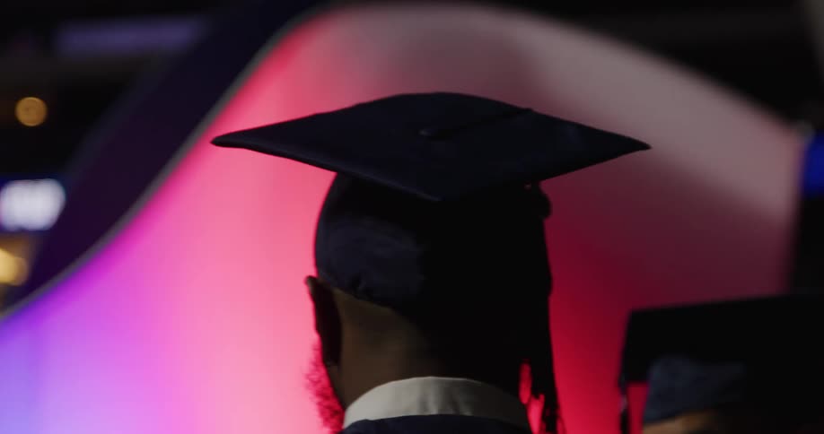 A person from the back in graduation clothes
