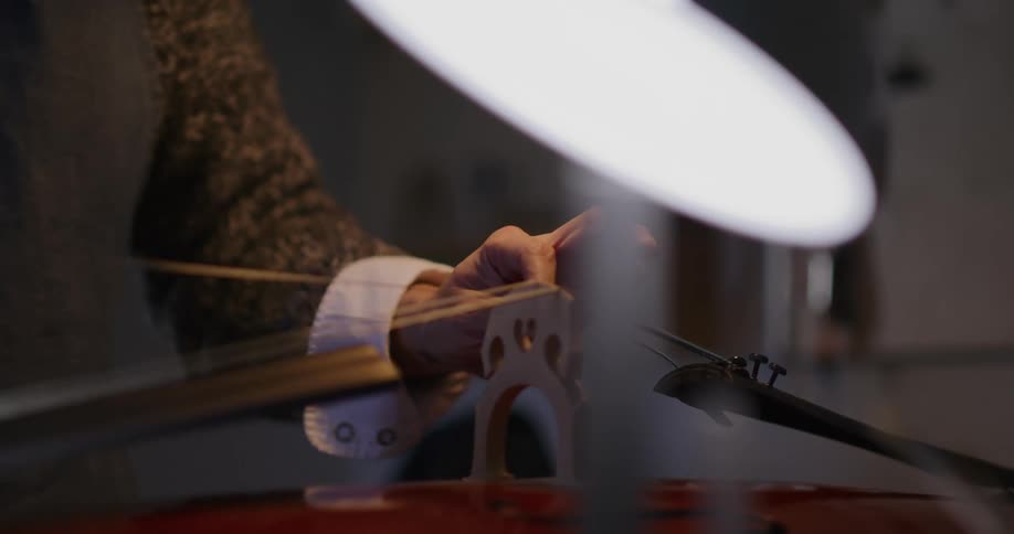 A person is placing a line on an object under a light bulb