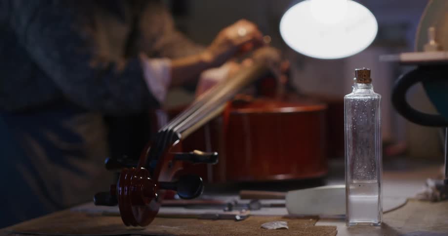 A worker is tuning a cello