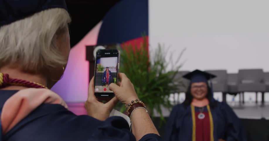 A graduate is posing for a picture