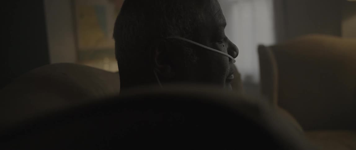 A man is sitting in a living room