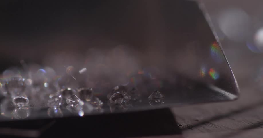 Tiny diamonds reflecting light on a tabletop