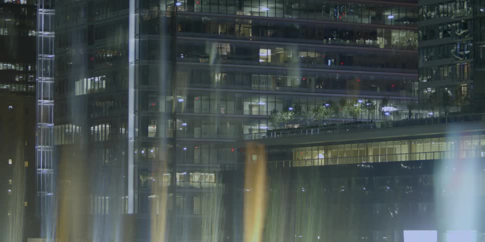 Lights shine from a city building at night
