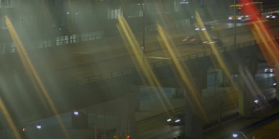 Many cars drive on a highway and a bridge over a highway