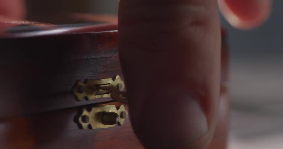 A wooden box is closed and latched shut