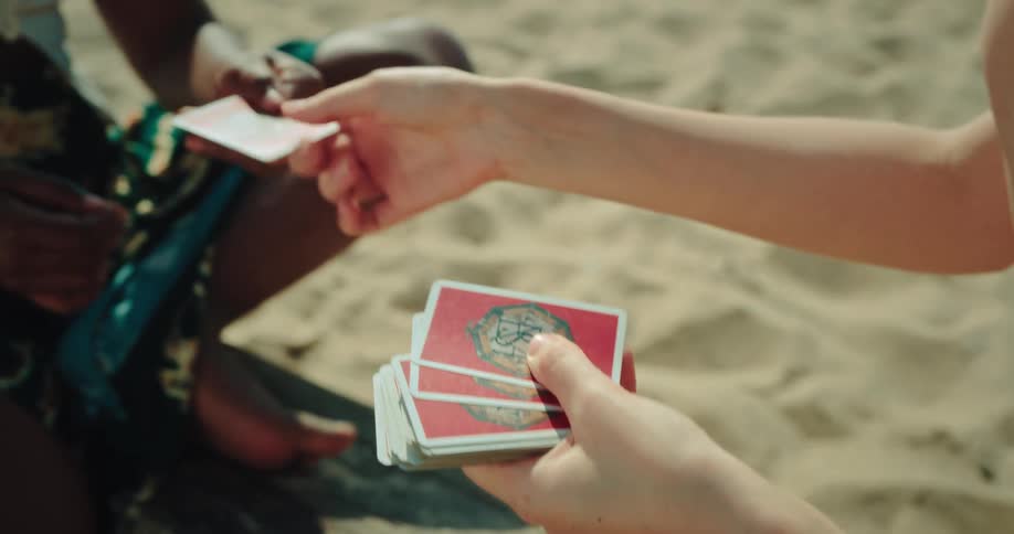 A person shuffling cards in a deck outdoors