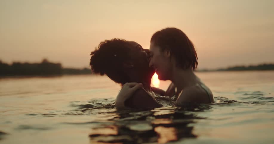 Two women playing inside a river