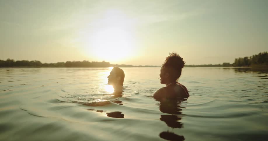 Two ladies swimming in the river
