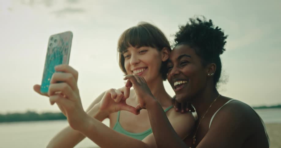 Two friends at the beach taking a selfie