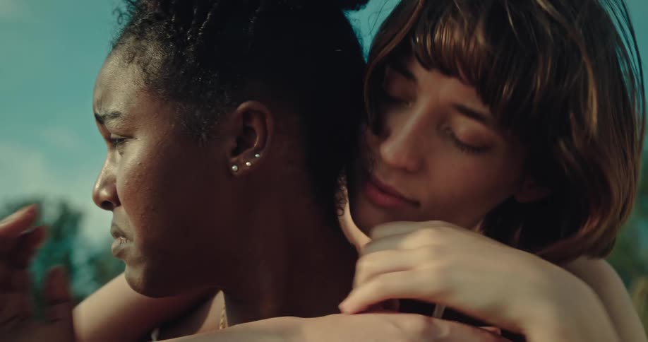 A clip of a sad black lady crying and her white female friend hugging and consoling her