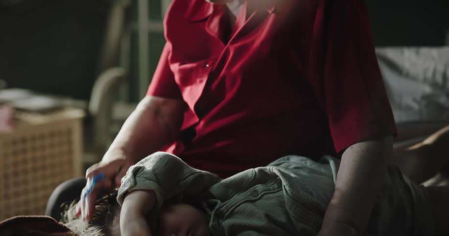 Grandmother beside her granddaughter who is lying down