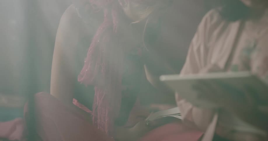 A woman drawing with a pen on a tablet