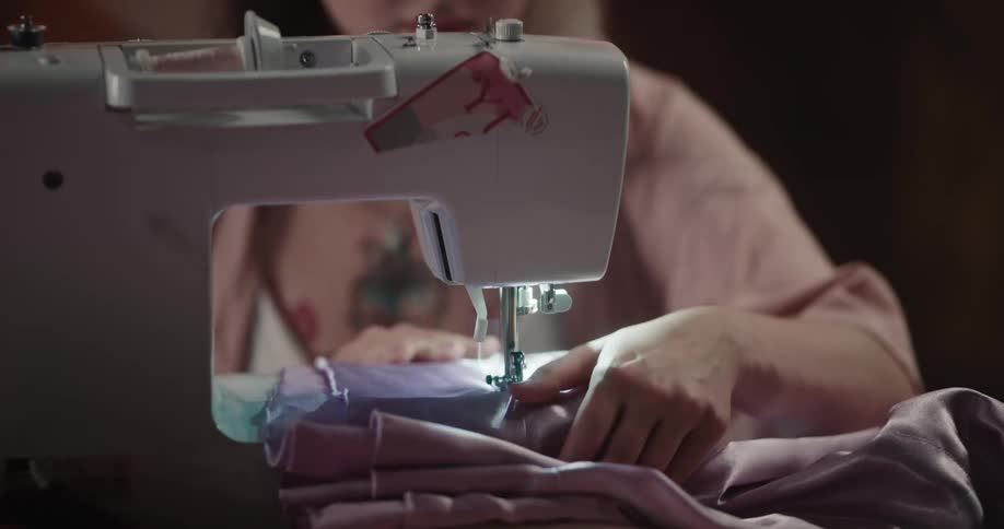 A woman is using a sewing machine
