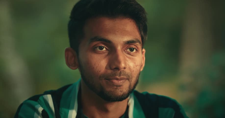 A face of a man who makes a smiling face and speaks