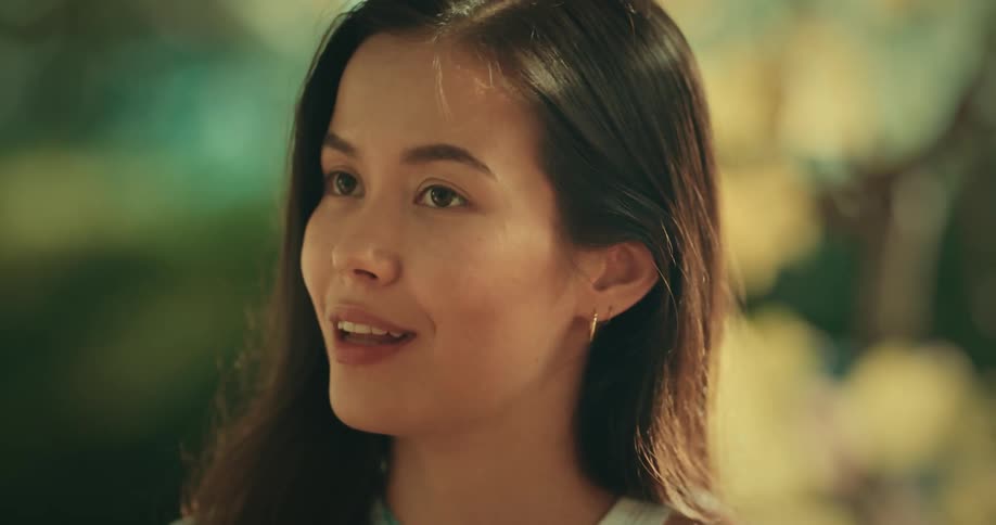 A young woman talking with friends outdoors