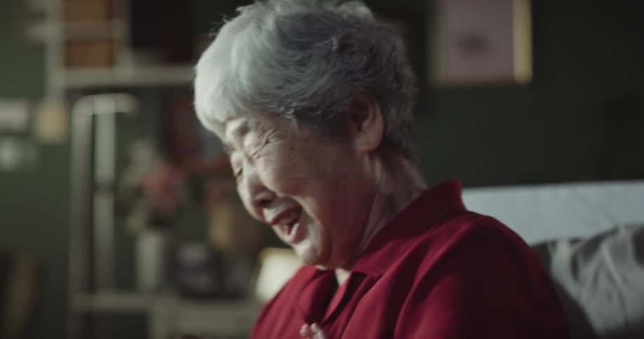 Grandmother cradling her crying grandson on her lap