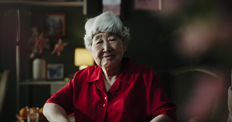 A clip of an old asian woman siting