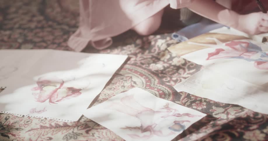 Woman squatting on the ground and writing in a notebook