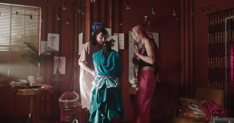 A clip of two tailor modeling a mannequin
