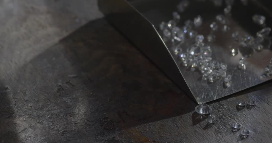Tiny diamonds reflecting light on a tabletop