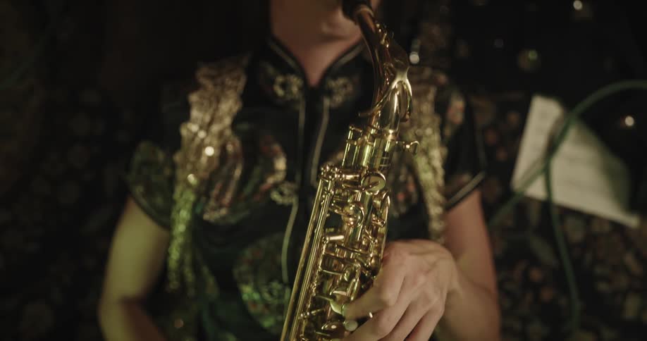 A woman is playing the saxophone