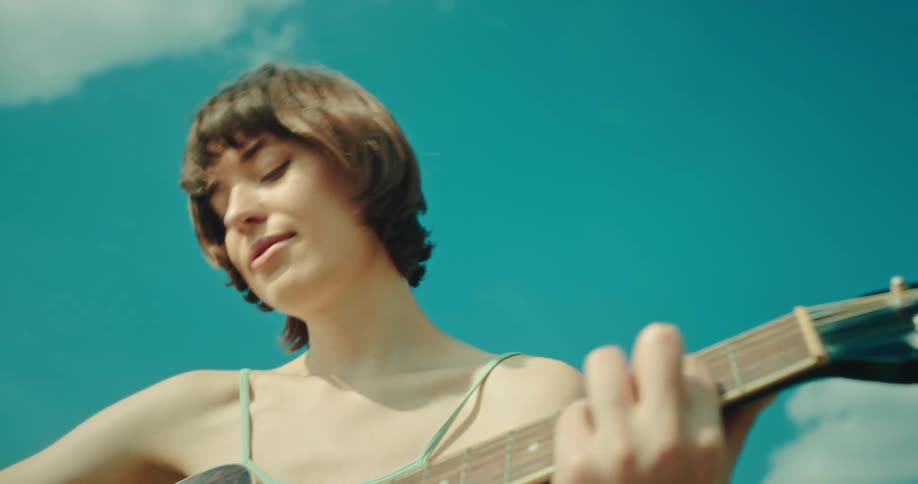 A woman is playing a guitar