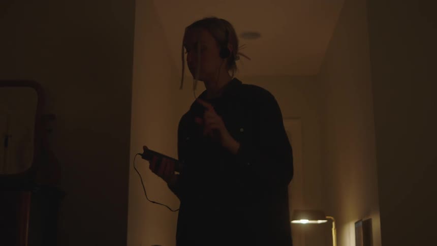 A woman listening to music on an mp3 player