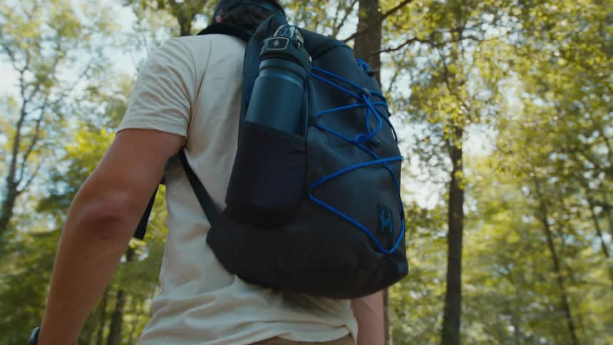 Man carrying a backpack walking on the forest