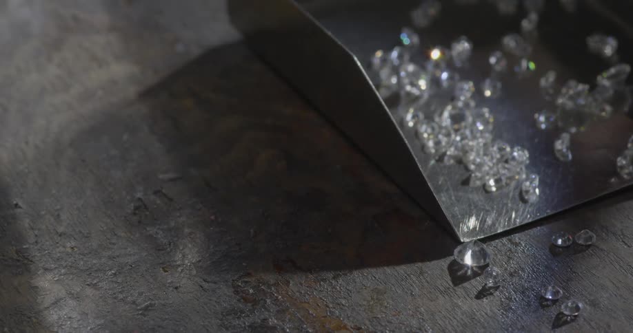 Small diamonds reflect light on a tabletop
