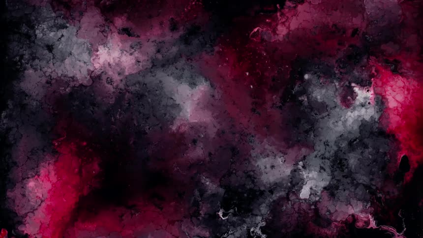 Extreme closeup of colored ink fluid boiling in slow motion