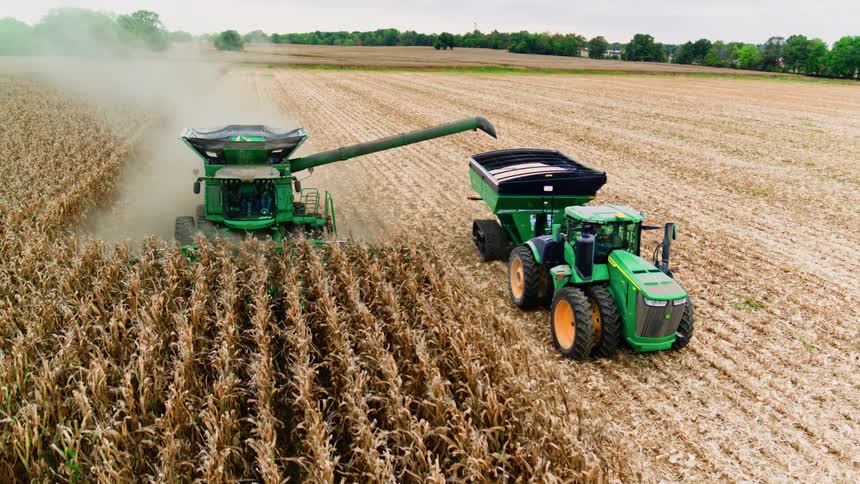 Front view of side by side tractors working efficiently to collect the farm's harvest