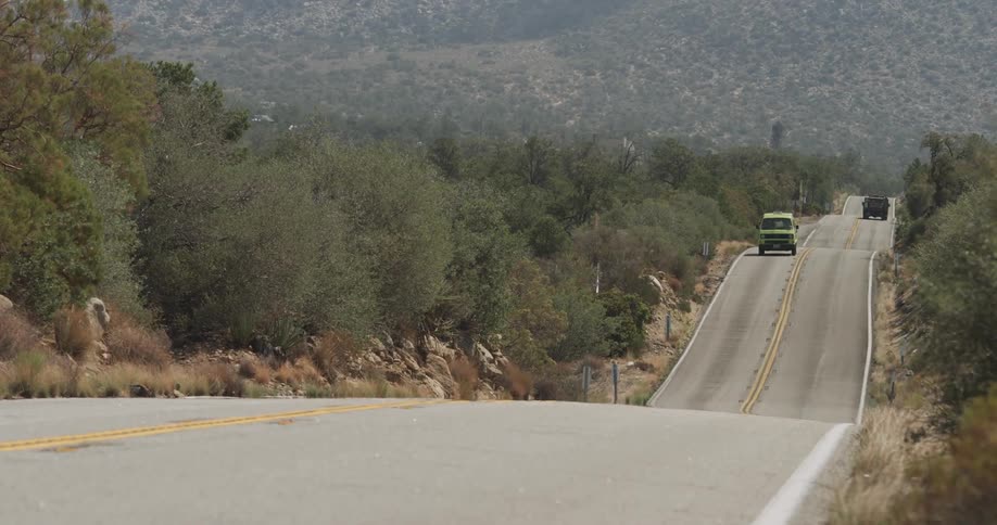 Traffic moves over hills on a mountain road