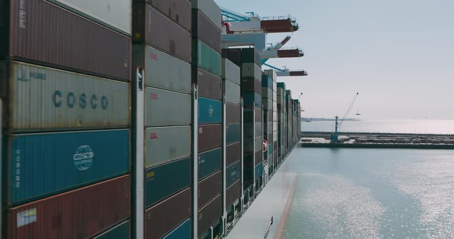 Aerial of a ship with containers in a port area