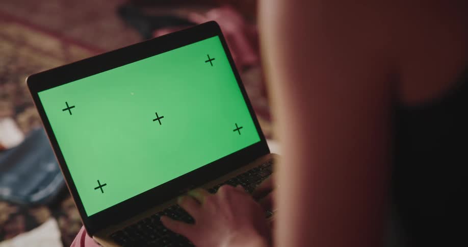 Woman sitting and typing on a laptop