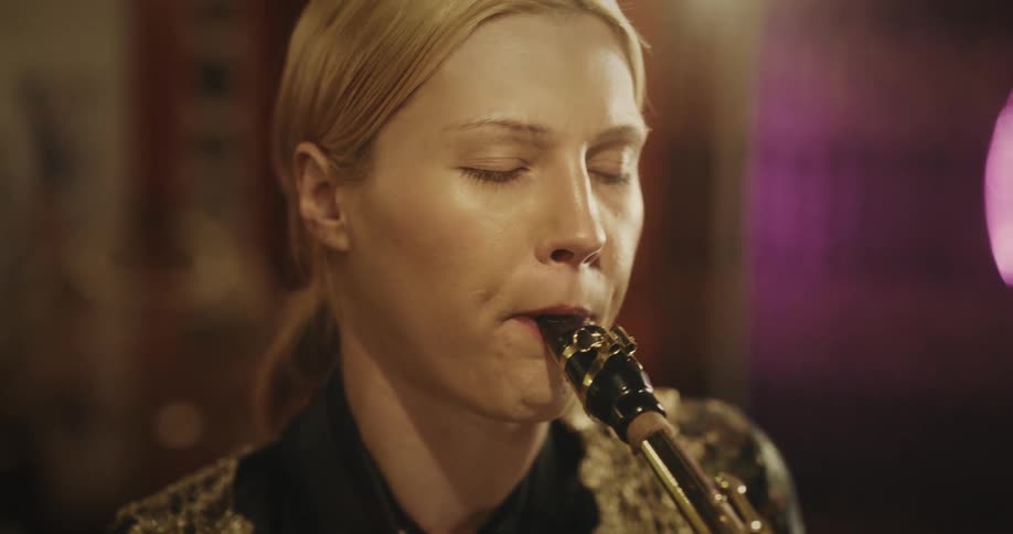 A woman is playing the saxophone