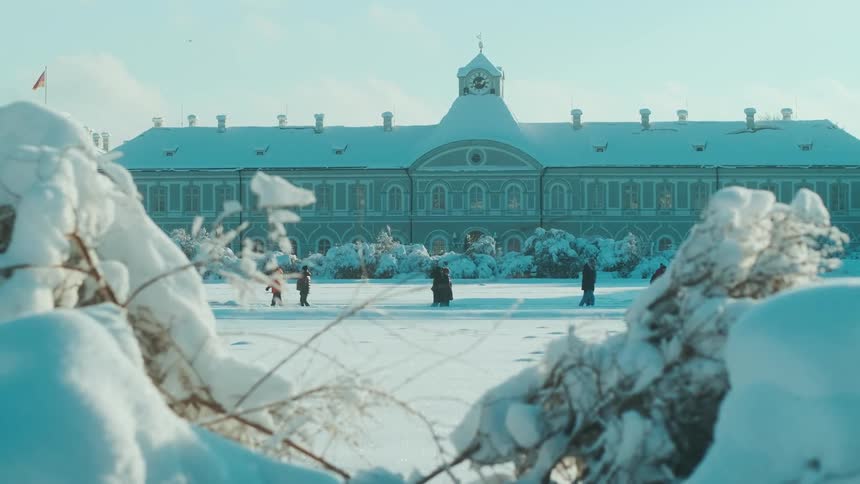 A group of people skating on the snow during winter