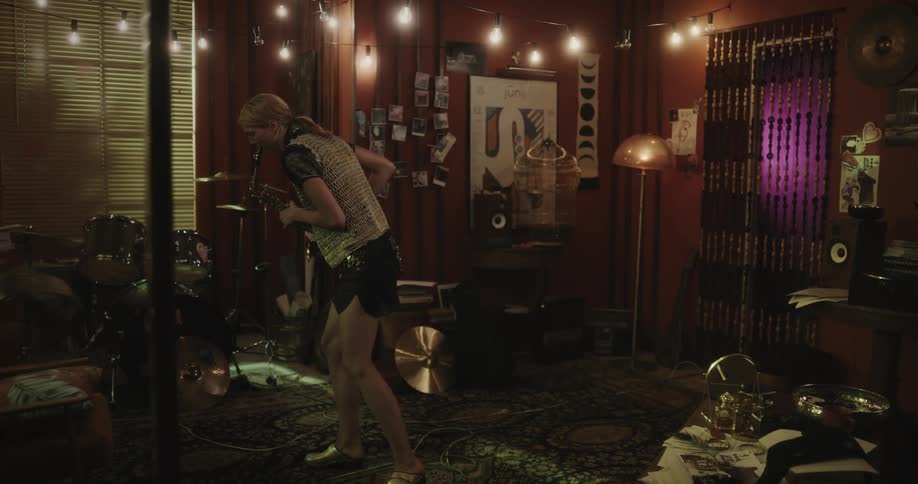 A woman playing the saxophone in a music studio