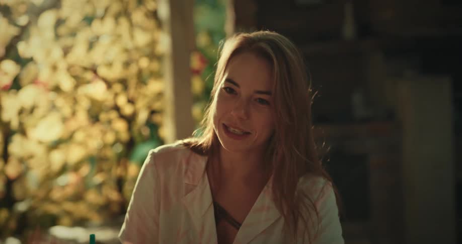 A woman is talking and laughing outside