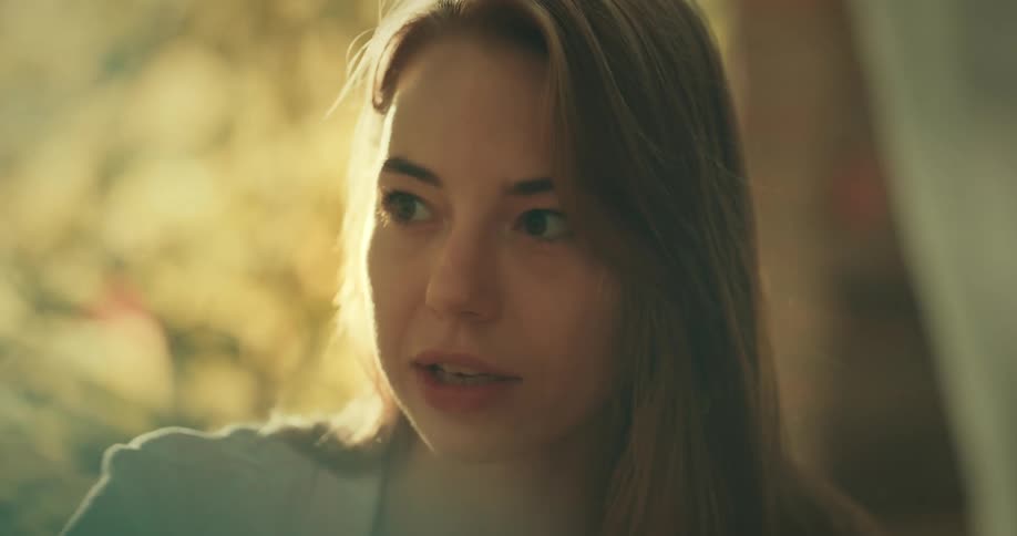 Woman with medium brown hair talks to someone on her right