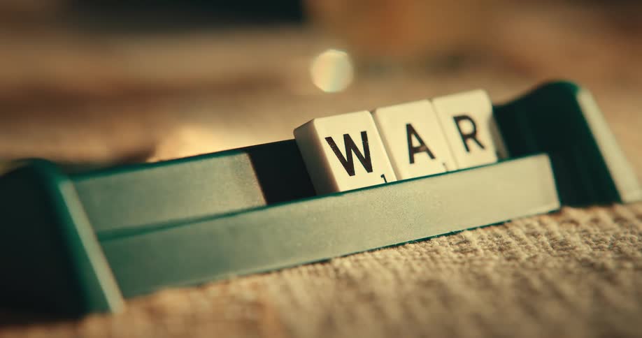 A hand arranging letters and forming words preparing to play scrabble