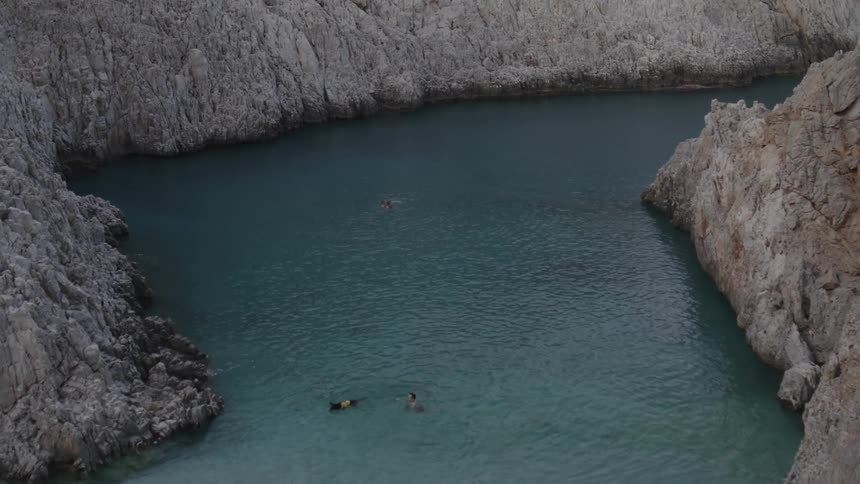 Light blue sea amidst coves and mountains during the day