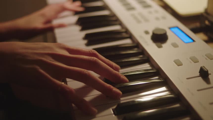 Closeup of a womans hands touching a digital keyboard