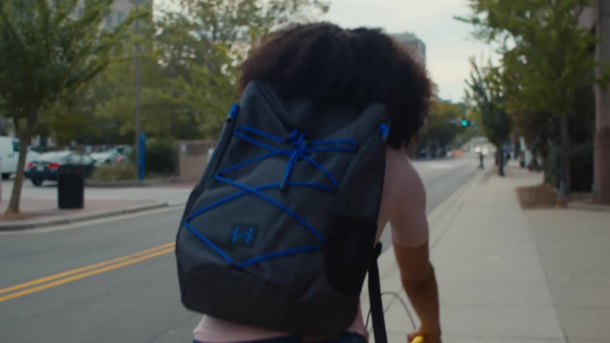 A woman going to work riding her bicycle through the streets of a neighborhood